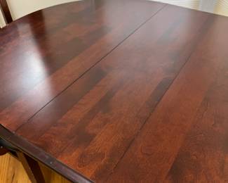 very nice 40" round dark wood table, shown with a 10" leaf inserted with one additional 10" leaf available + 6 chairs