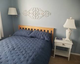 Full bed; floor lamp; end table; table lamp