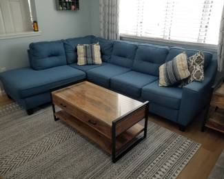 Nearly new sofa with chaise; coffee table matches end table; area rug