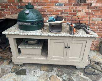 Big green egg built into a custom granite top cabinet with all accessories.