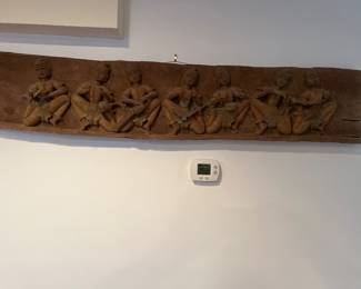 Wood carving of figures playing musical instruments