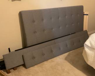Upholstered queen size bed frame includes headboard, footboard and side rails with slats for mattress