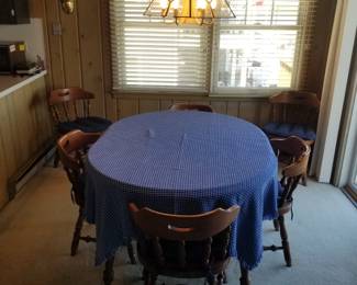 Sturdy dining table seats 6; extra leaves included but not shown; chandelier
