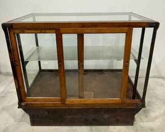H. A. Heimann Oak Glass Display Case on Pedestal Base with Beveled Glass Top and Double Sliding Doors, Glass Shelf.