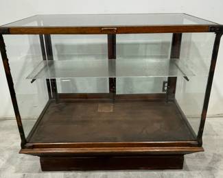 H. A. Heimann Oak Glass Display Case on Pedestal Base with Beveled Glass Top and Double Sliding Doors, Glass Shelf.