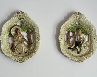 Vintage Capodimonte pair of wall hanging plaques, with a male and female figure within the frame 