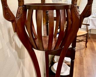 Three carved Swan’s heads top this interesting wood planter/fern stand