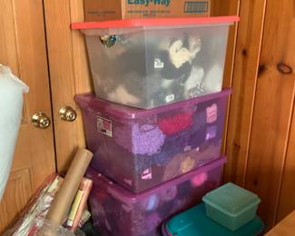 Totes full of yarn and crafting supplies.