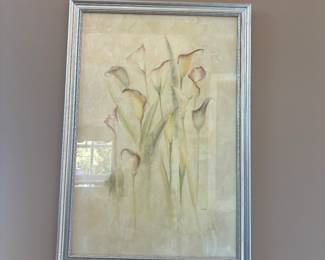 Elegant framed artwork featuring soft watercolor-style calla lilies in muted tones of cream, green, and blush. Subtle texture adds depth, making it a perfect piece for traditional or modern décor. Housed in a silver frame for a refined finish.