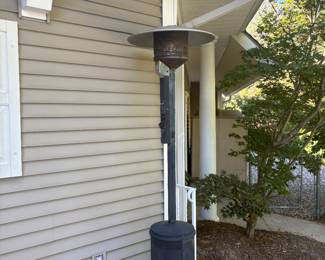 Tall freestanding propane patio heater with classic dome-style top. Provides powerful heat output, perfect for extending outdoor gatherings into cooler evenings. Black metal base with storage compartment for propane tank