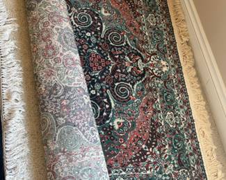 Traditional Area Rug with Fringe
Beautiful woven area rug featuring an ornate teal, red, and cream paisley-inspired design with scrolling detail and knotted fringe edges.