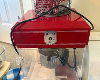 Retro-style Waring Pro popcorn machine. Compact countertop design with clear viewing window, built-in kettle, and original instruction manual included. Great for movie nights at home.