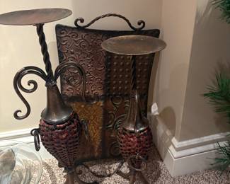 Wrought Iron & Woven Candle Holders (Pair)
Set of two tall candle holders featuring twisted iron stems, woven basket-style bases, and round tops. Warm rustic finish, great for floor or hearth display.