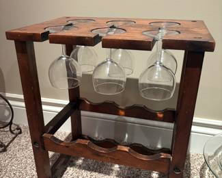 Wooden Wine Rack with Glass Storage
Rustic wooden wine rack with slots for multiple bottles and a top rack designed to hold stemware. Includes four wine glasses.