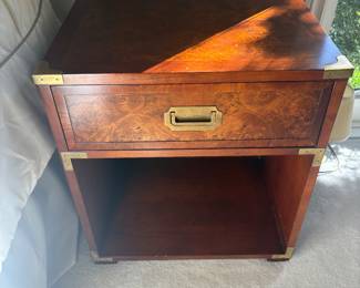One of 2
Hekman Campaign-Style Nightstand
Classic Hekman nightstand with a single drawer, recessed brass campaign pull, and open lower shelf. Finished in burled veneer with brass corner accents.
• Condition: Very good, some light wear consistent with use