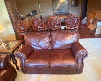 Coordinating brown leather loveseat with rolled arms and nailhead trim. Great for smaller spaces or paired with the sofa. Gently used, comfortable, and well-built.