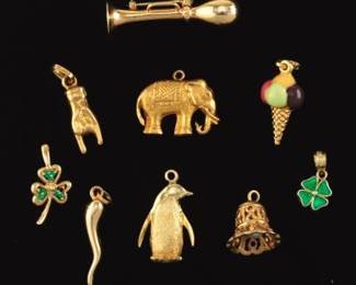 Collection of Nine Gold and Enamel Charms and Pin