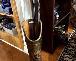 Wooden umbrella stand with crest.