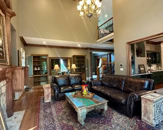 Karastan medallion area rug and brown leather sofas 