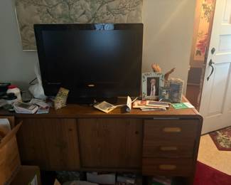 . . . desk or dresser with flat-screen TV atop