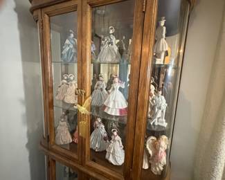 . . . beautiful curved-glass curio cabinet filled with figurines