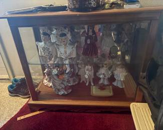 . . . highlighting a two-tiered curio cabinet