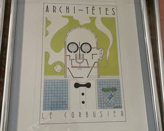 The image is a framed print titled "ARCHI-TÊTES LE CORBUSIER". It's part of a series created by architect and cartoonist Louis Hellman, known for his satirical "Archi-têtes" (Architectural Heads) caricatures. This particular print depicts the famous architect Le Corbusier as a building plan, incorporating elements of his architectural style and principles into his facial features and attire