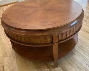 Round Wooden Coffee Table with Decorative Base and Bottom Shelf