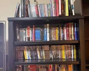 Diverse Collection of DVDs and Books with Notable Titles