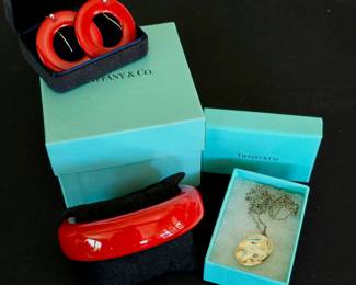 Tiffany & Co Elsa Peretti 18kt white gold and red lacquer earring and bracelet set.  Tiffany & Co Elsa Peretti sterling silver "Leo" pendant necklace.