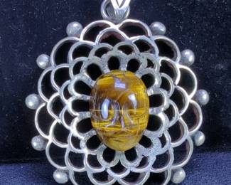 Los Ballesteros Carved Tiger's Eye Pendant Set In Sterling Silver