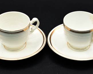 pair of gold tone rimmed cup and saucer sets