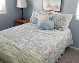 Full bed; nightstand/end table. Beachy art