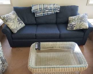 Couch; glass top wicker coffee table