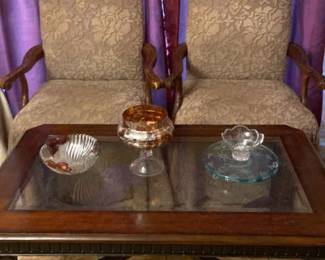 Two Identical Chairs, A Wooden Coffee Table With Glass Center And Decor