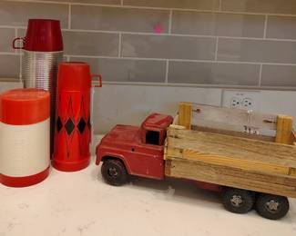 Thermoses and an old red truck.