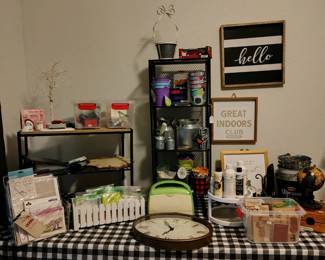 Miscellaneous crafting items, clock, artwork, decorative tins.