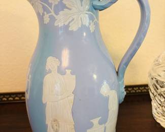 Interesting.  A woman carrying a vase on a vase.  