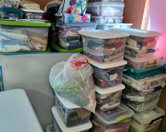 Tubs of fabric. Most tubs have yards of uncut fabric. Some have pieces already cut for quilts.