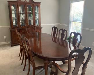 America Drew Dining Furniture . 8 chairs in excellent condition, 2 arm chairs and 6 side chairs. Table has 2 removable leaves to seat 4-6-8 place settings. Comes with a custom size heat proof mat. Hutch is 2 pcs. Can be used as a china cabinet or side buffet.
