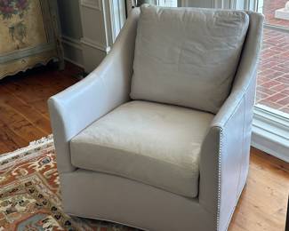 There are 2 almost new expensive leather swivel chairs