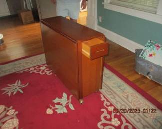 Romanian drop leaf table with inside storage for nesting chairs