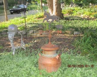 Old weather vane on tops of old milk can