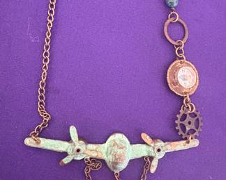 Airplane with compass necklace
