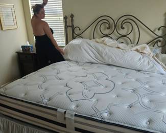 King size new mattress alongside Laura showing it off.
Vanna White you have competition...