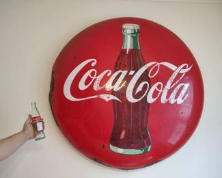 Huge coca cola button sign .