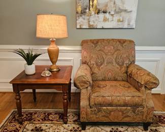 Overstuffed chair, table and lamp