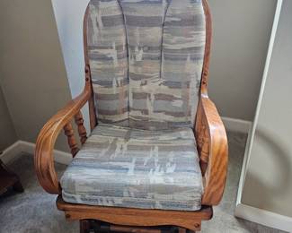 Rocker with oak arms and back and seat cushions in blues and cream