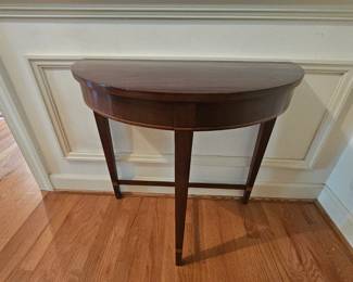 Small mahogany demilune table with inlay