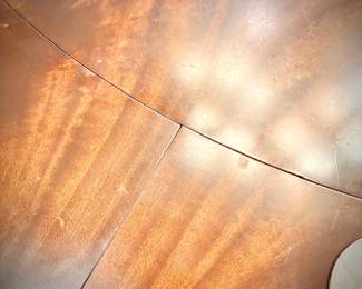 Antique mahogany round dining table with brass clawed feet. This table has leaves on the OUTSIDE of the table - remove them to make the table smaller. Leaves are numbered to ensure the wood grain matches up.
